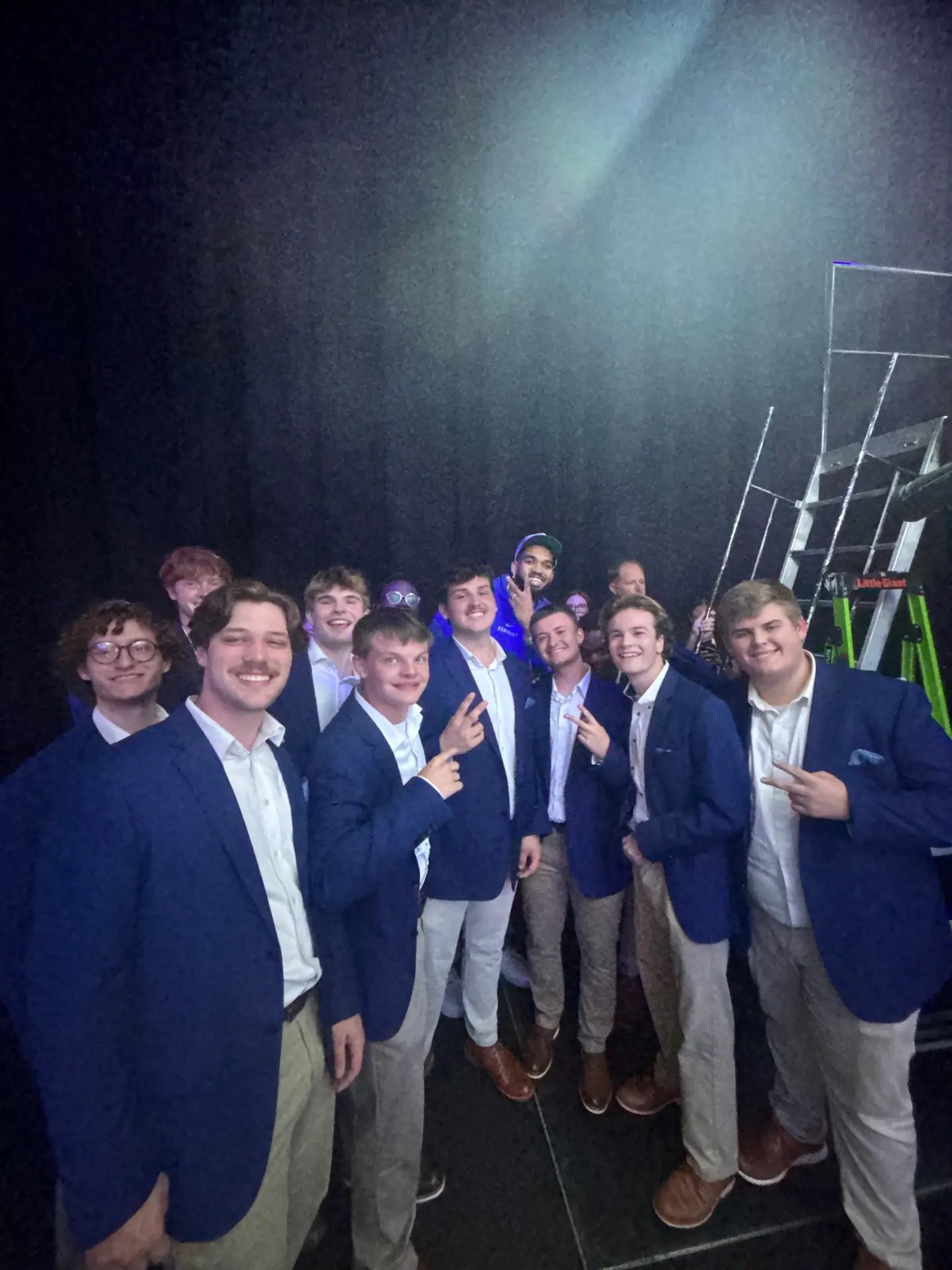 acoUstiKats members taking a selfie backstage in blue blazers.